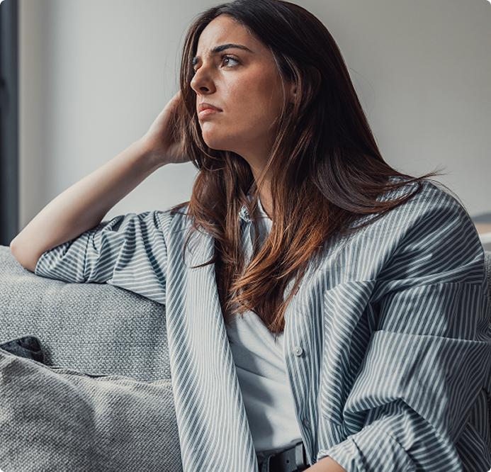 Woman looking tired and reflective at home, showing early signs of lifestyle imbalance